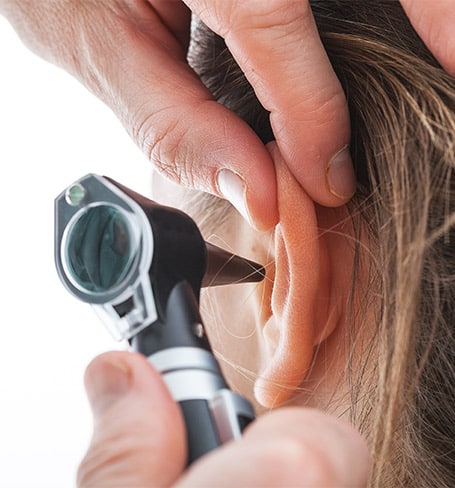 Woman getting her ears examined by an audiologist